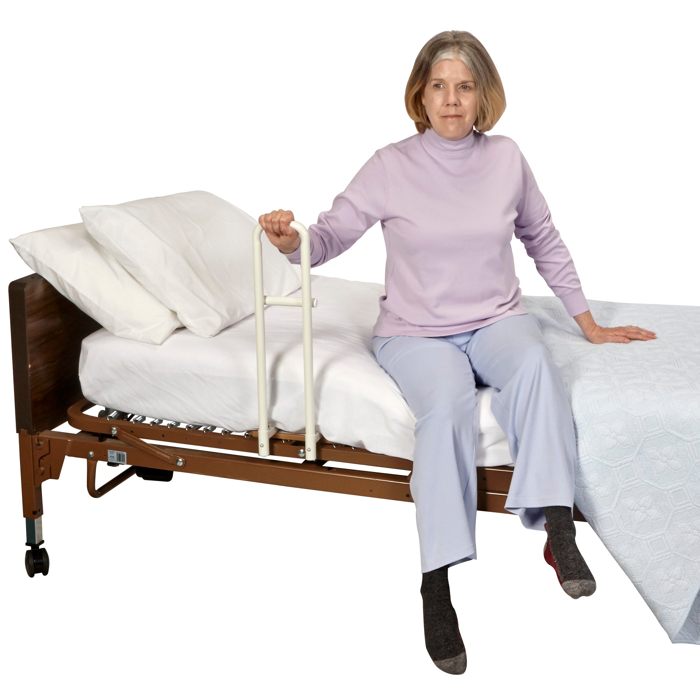 A person sits on a bed using the Transfer Handle Hospital Model for Spring-Based Beds for support, showing its functionality.