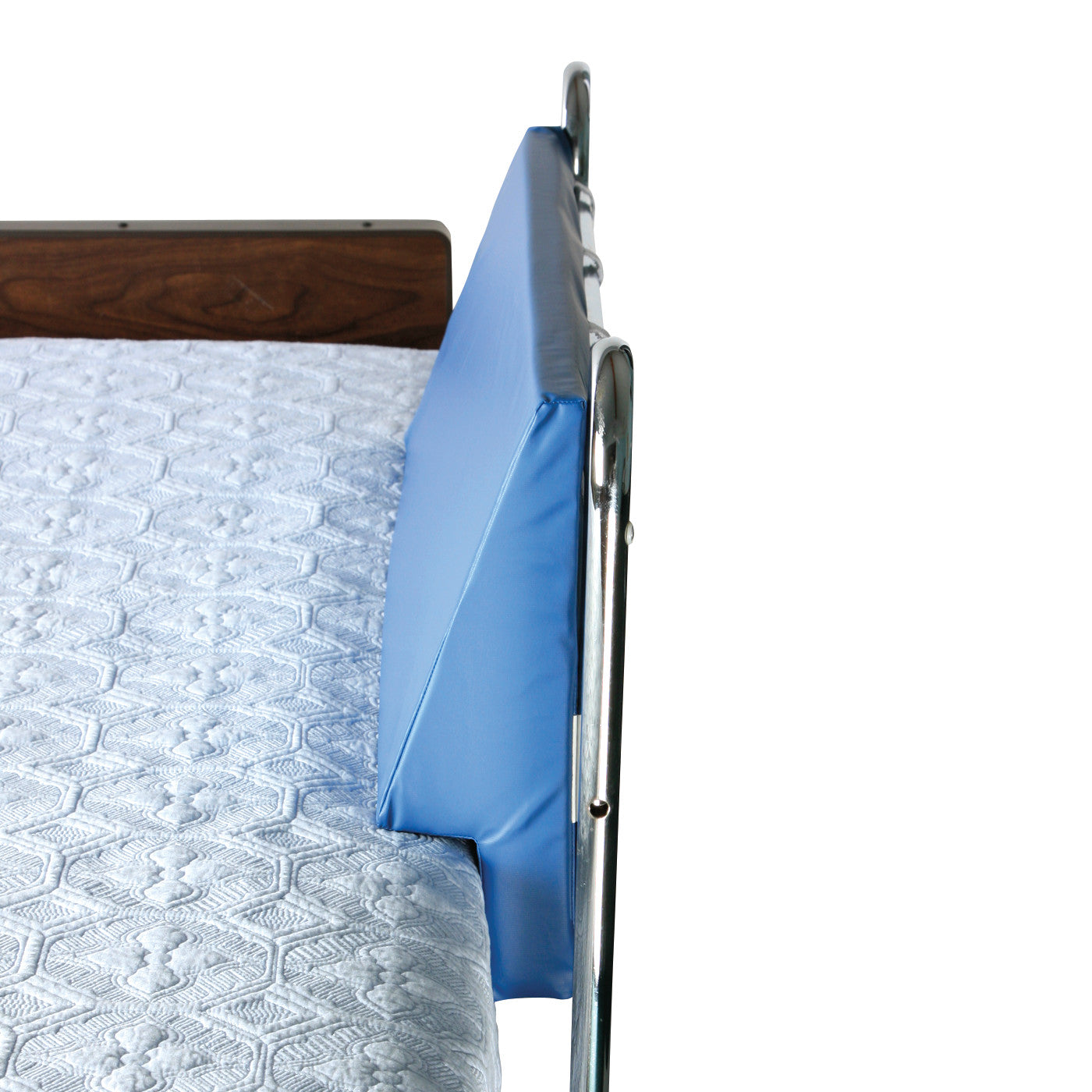 AliMed Upholstered Foam Bed Bolster attached to a hospital bed's side rail, alongside a blue quilted mattress cover.