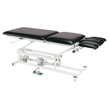 The Armedica AM-550 Treatment Table is an adjustable, black-cushioned medical table with a white metal frame and foot pedal control.