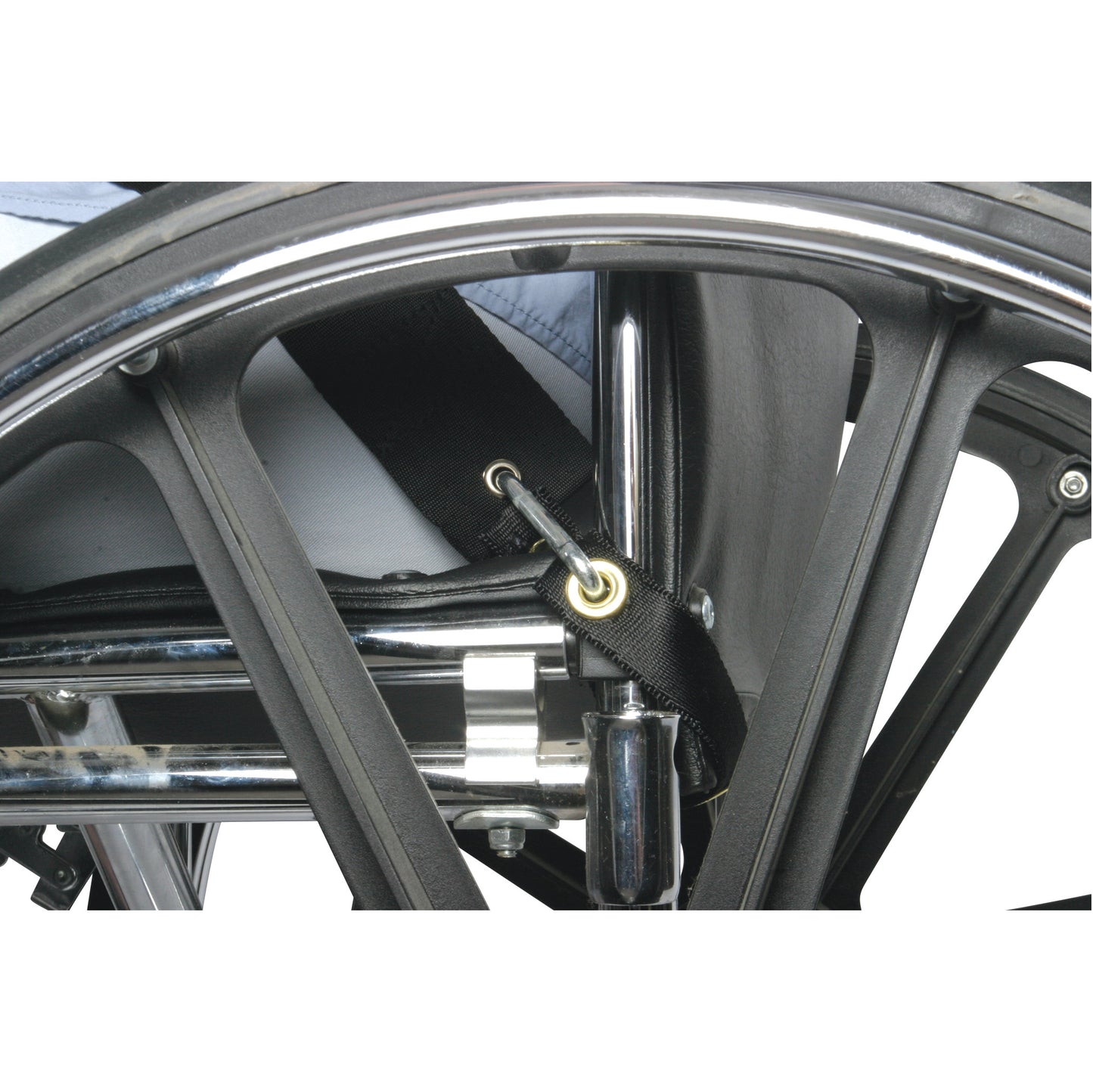 A close-up of a wheelchair's wheel and frame, showing the AliMed UniLoop Seatbelt Attachment secured to the frame with a hook.