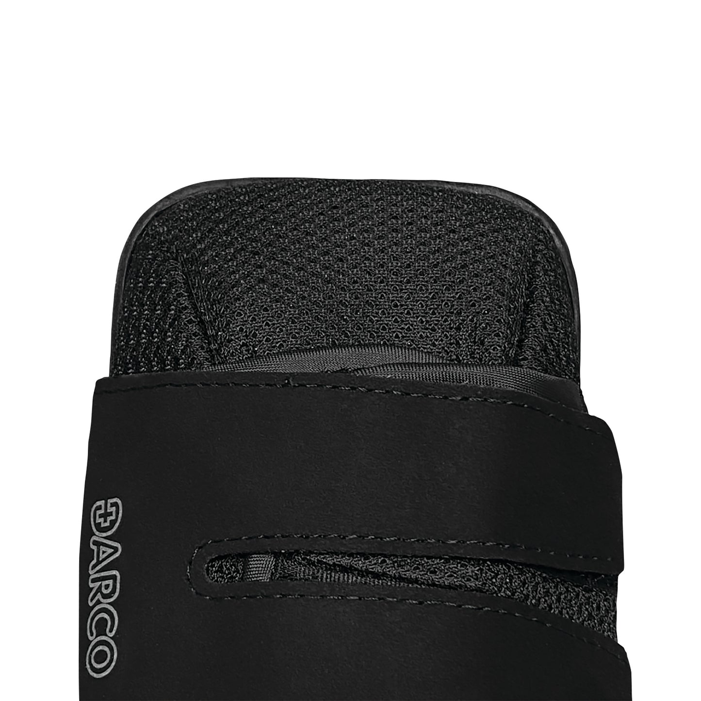 Close-up of the top of a black DARCO HeelWedge Healing Shoe, featuring a textured fabric and a strap with the brand logo visible.