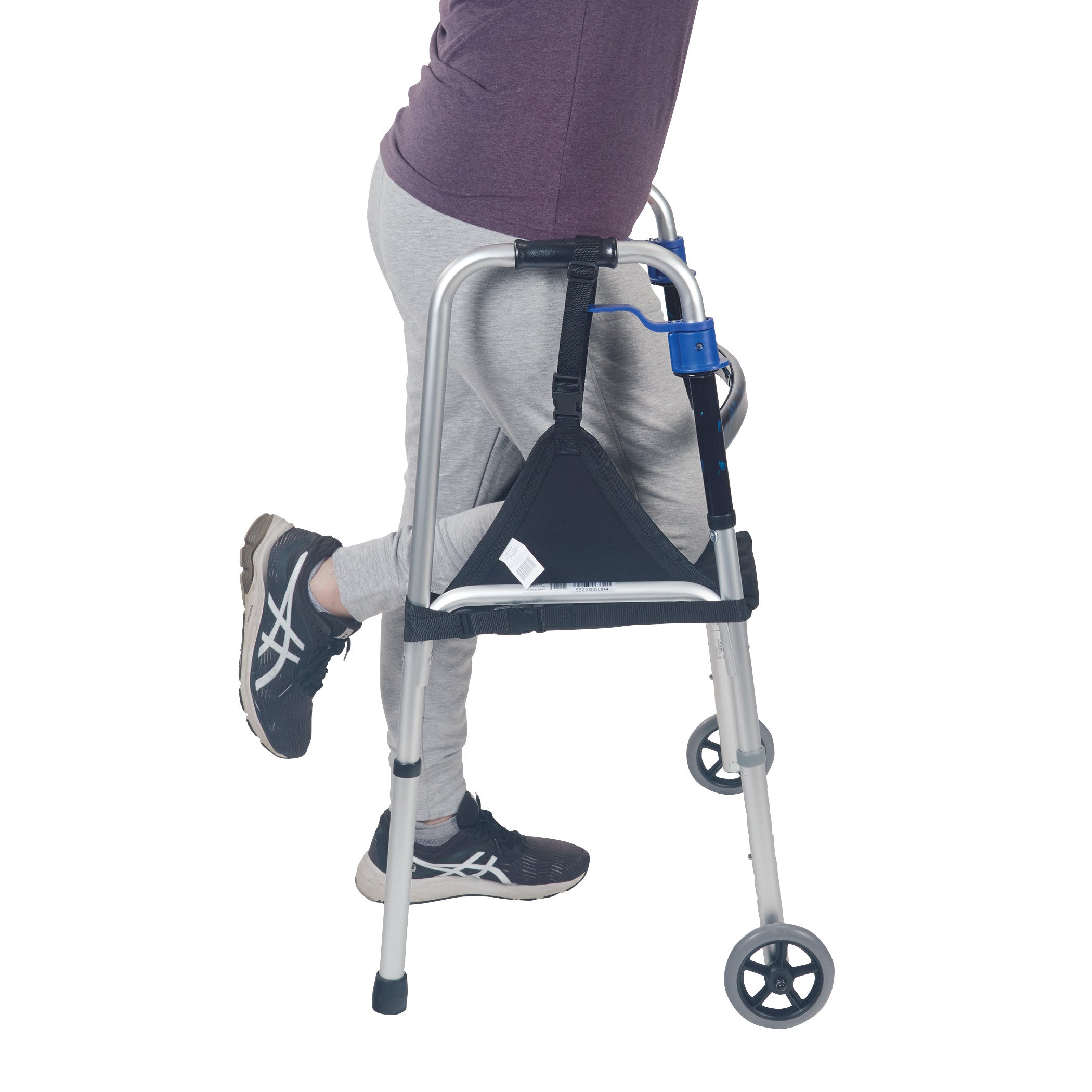 Person using a walker with a "SafetySure The Knee Sling" attached, supporting their bent knee.