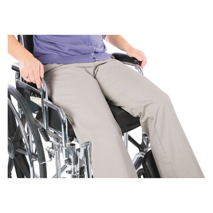 A person sits on an AliMed AliHip Wheelchair Cushion within a wheelchair, wearing a blue top and beige pants.