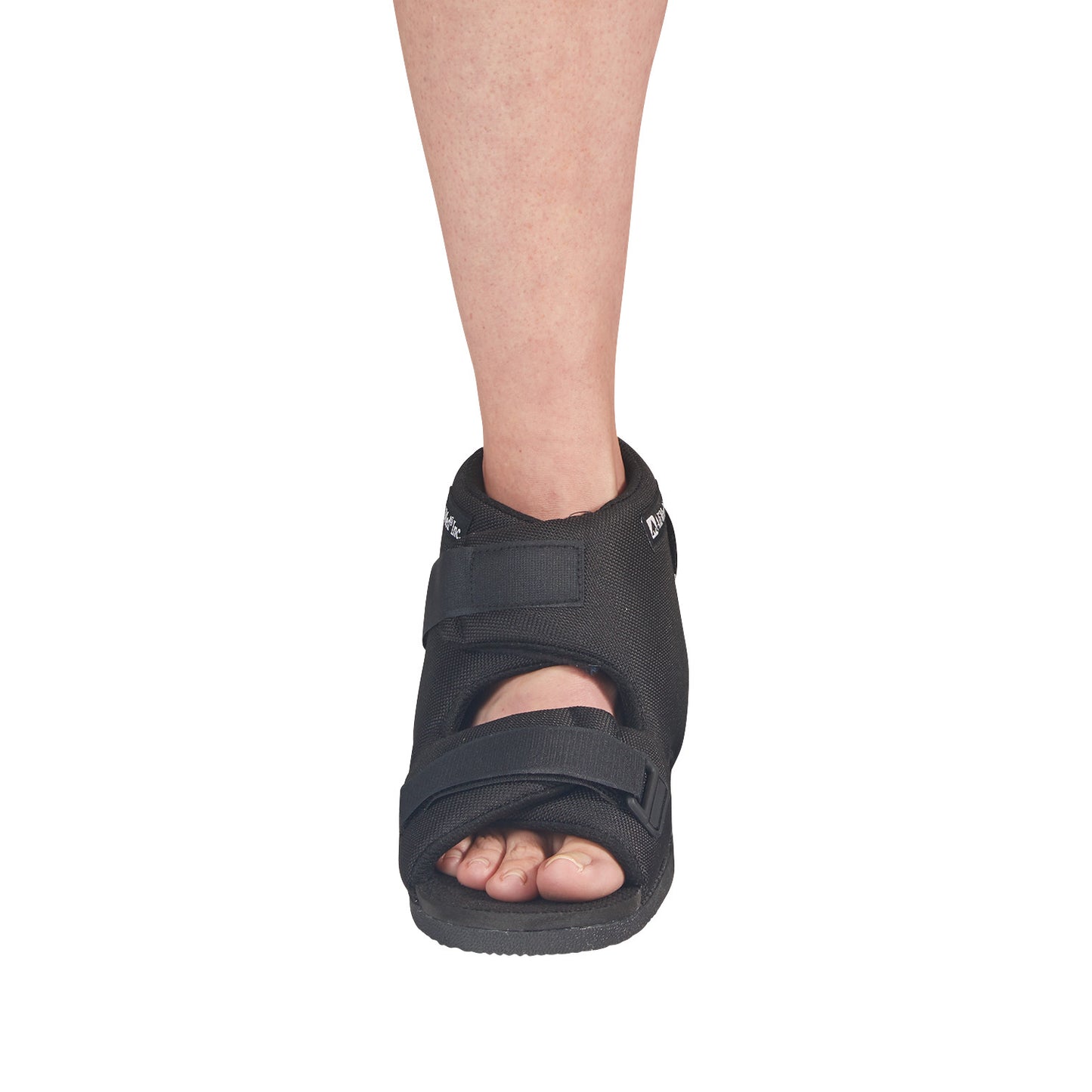 A foot wearing an AliMed Open Heel Orthosis, a black medical shoe with adjustable straps, exposing the toes and heel.