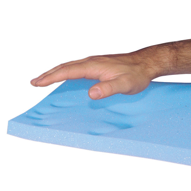 A hand presses on the AliMed T-Foam Uncovered Wheelchair Cushion, leaving an imprint in the blue memory foam surface.