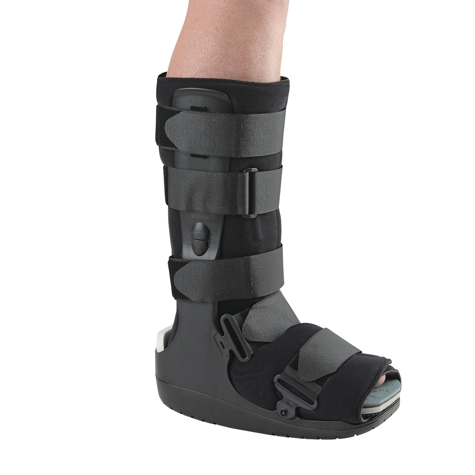 An Ossur DH Offloading Walker boot on a leg, featuring adjustable straps and a thick sole, designed for foot injury protection.