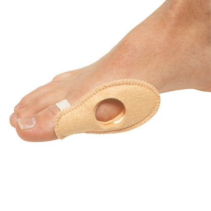 A foot with the PediFix FELTastic Bunion Shield, a beige felt pad covering a bunion, secured by an elastic loop around the toe.
