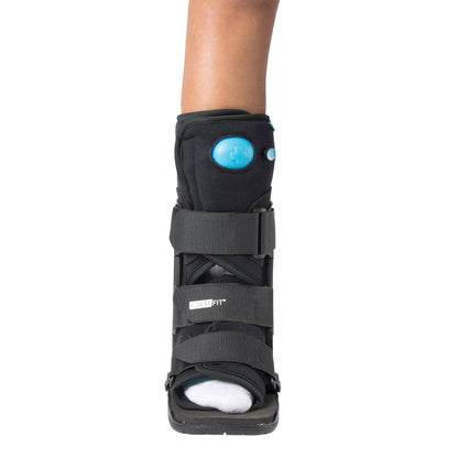 A leg wearing an Ossur Formfit Low-Top Air Walker with adjustable straps and a visible blue air pump button on the front.