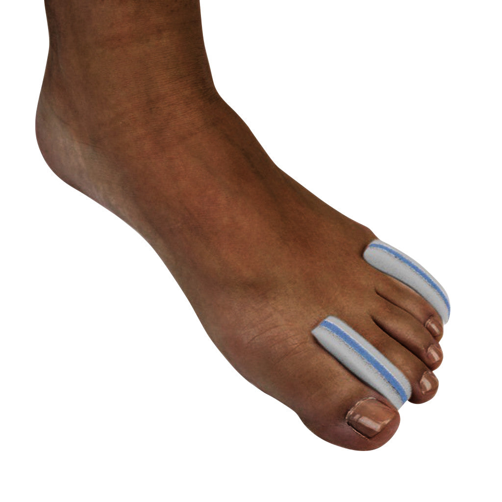 A foot wearing Silipos Foam Toe Separator on two toes. The separators are white with blue edges.
