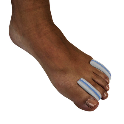 A foot with Silipos Foam Toe Separators placed between the big toe, second, and third toes, providing cushioning and alignment.