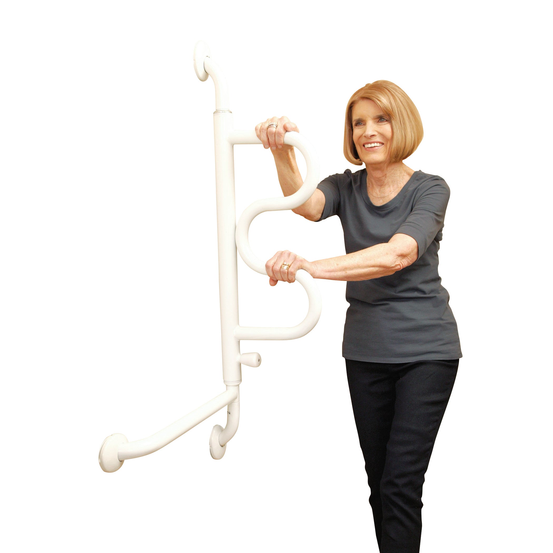 A woman demonstrates the Stander Curve Grab Bar, featuring a curved, white handle and vertical mount for support and stability.