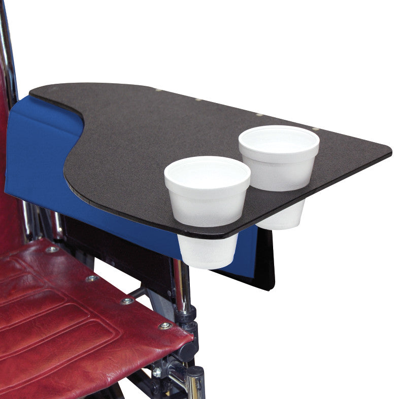 The SkiL-Care Flip-Top Tray with Cup Holder is attached to a wheelchair, featuring two built-in cup holders and a black surface.