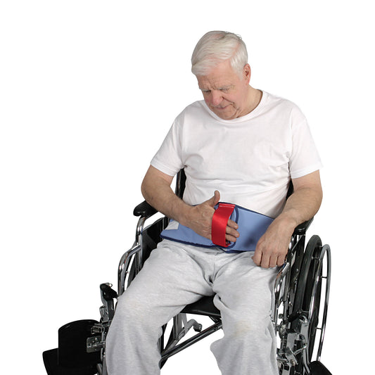 An elderly man sits in a wheelchair using the AliMed Restraint-Free Cushioned Lap Belt, which is blue with a red handle.