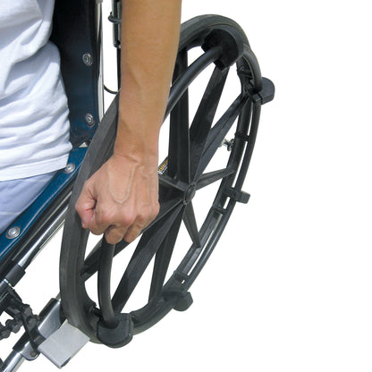 A person grips a wheelchair wheel using the Shove-a-Lugs Wheelchair Grip Attachment, designed for improved control and ease.