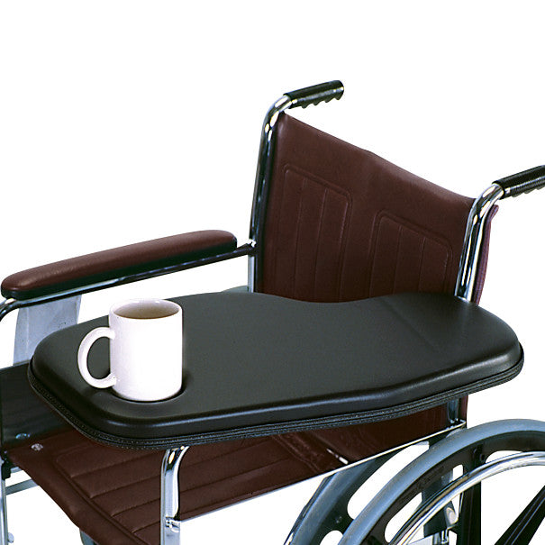 A wheelchair with a Therafin Padded Flip-Away Arm Support is shown, holding a white mug on the black padded surface.