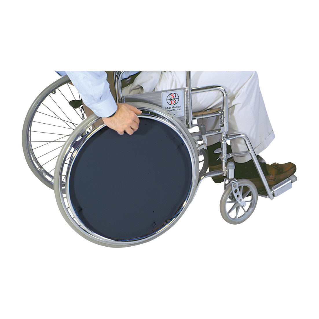 A person uses the AliMed Wheelchair Spoke Cover, which fits over the wheel spokes of a wheelchair for protection and aesthetics.