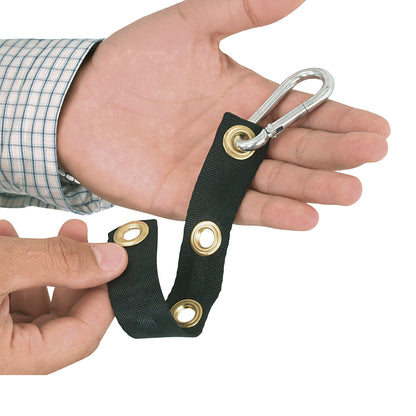 A person holds the AliMed UniLoop Seatbelt Attachment, featuring a black strap with metal grommets and a silver carabiner clip.