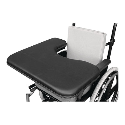 A Therafin Padded Three-Quarter Tray is attached to a wheelchair. It features a U-shaped cutout and cushioned black surface.