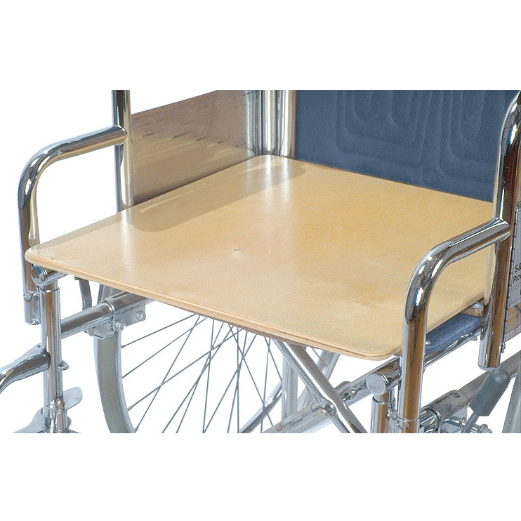 A wheelchair with an AliMed Wheelchair Board mounted on the armrests, providing a flat wooden surface over the seat.