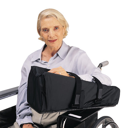 An elderly person uses the SkiL-Care Elevated Wheelchair Mobile Arm Support, a padded black armrest attachment on a wheelchair.