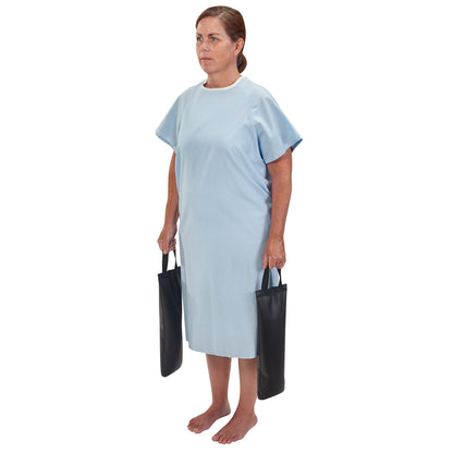 A woman holds two AliMed MR-Safe Cervical/Traction Sandbags while wearing a light blue hospital gown and standing barefoot.