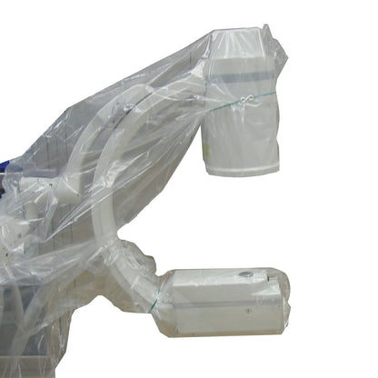 A TIDI Disposable Mini C-Arm Drape covers a piece of medical imaging equipment, featuring plastic wrapping and a visible fastening strip.