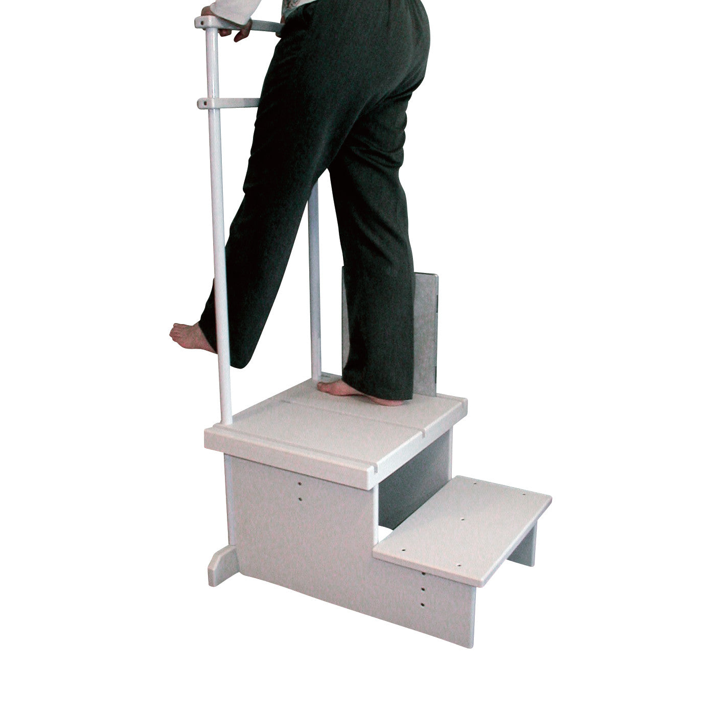 A person stands on the Two-Step Positioning Platform for CR Systems and DR Systems, gripping a vertical handle for support.