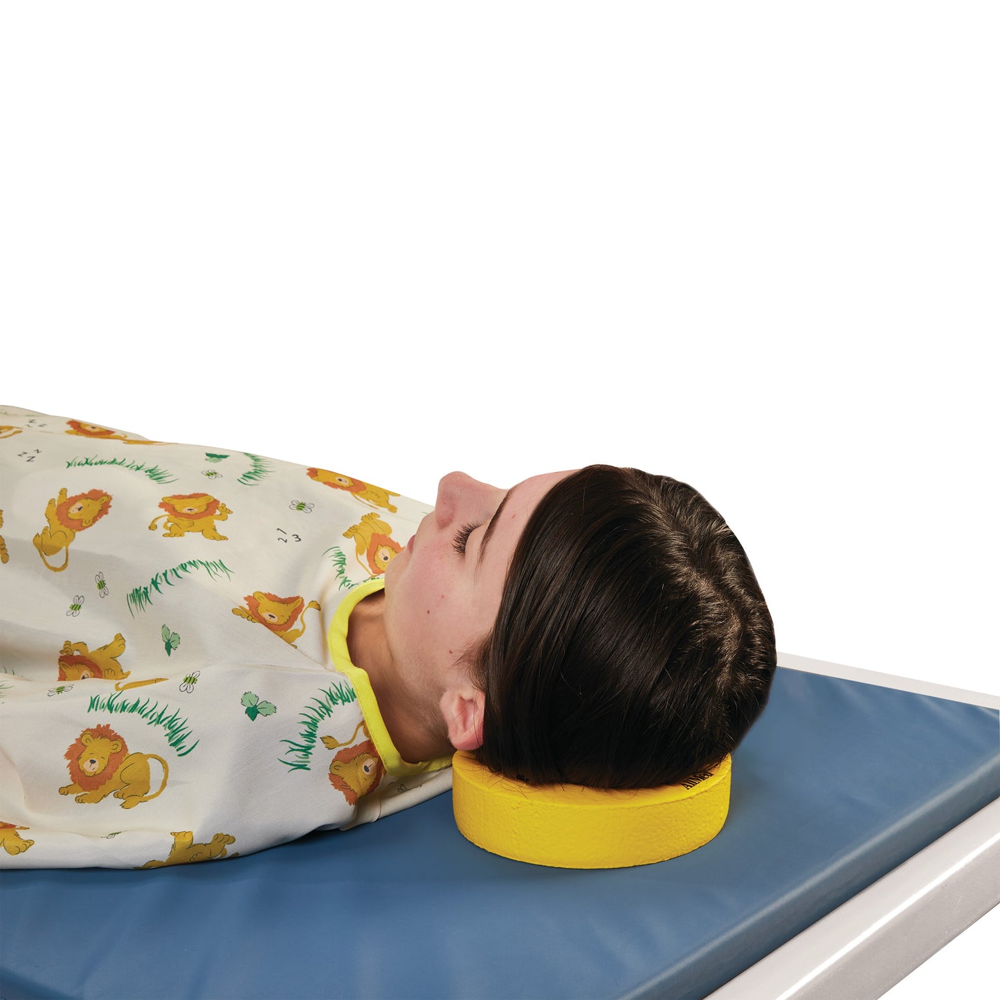 A person lies on a blue mat with their head resting on an AliMed Protecta-Coat Head Donut while wearing a lion-themed gown.