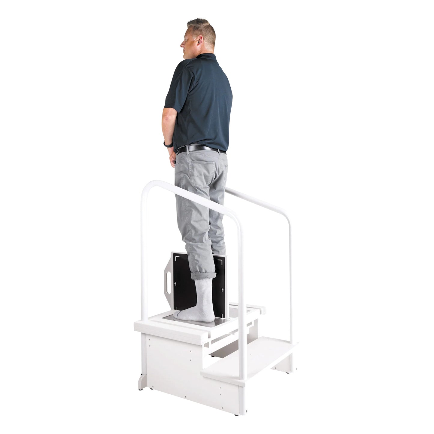 A person stands on the Two-Step Positioning Platform for DR Systems: Siemens Ysio, GE FlashPad, Philips Wireless, with handrails for support.