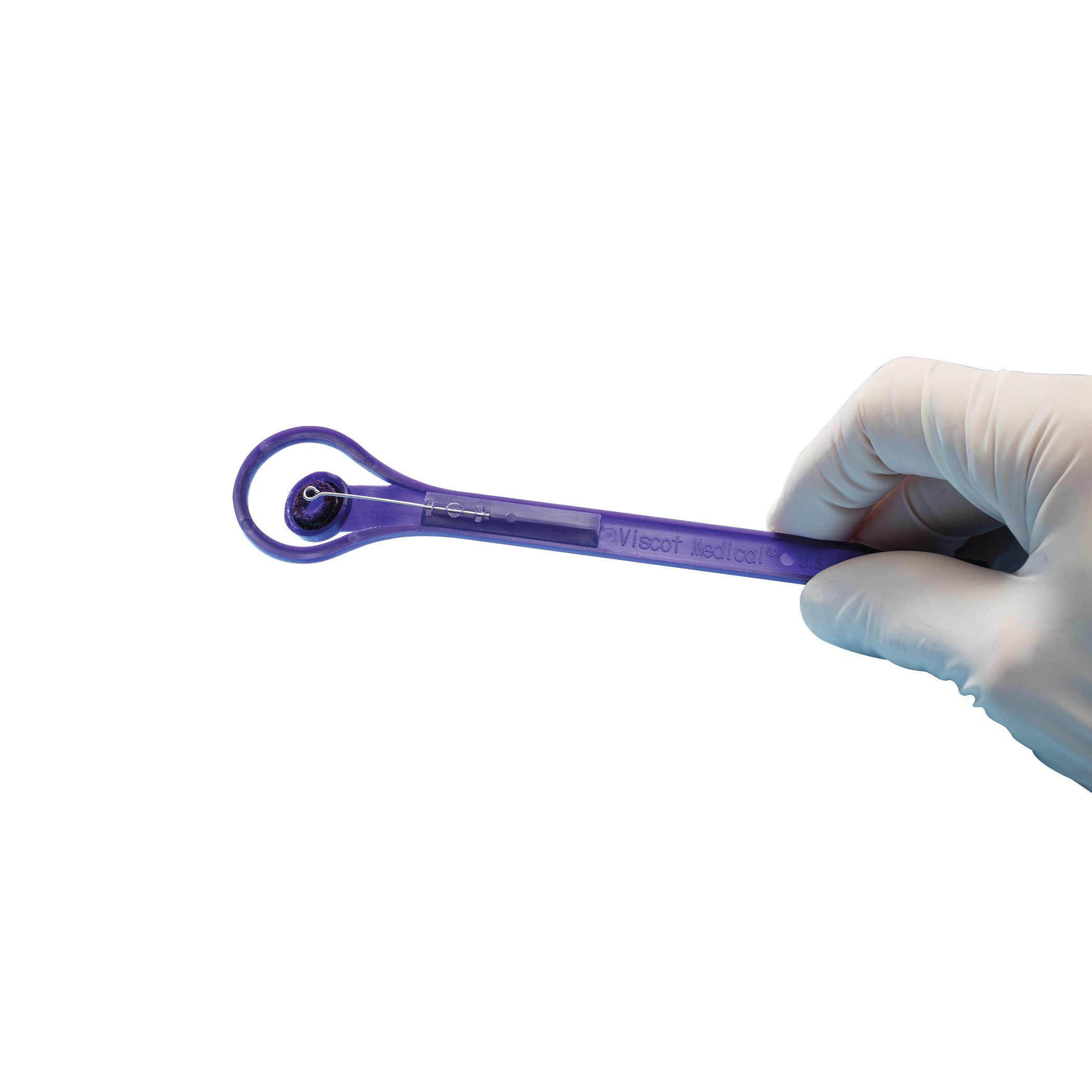 A gloved hand holds a Viscot Accumark Radiopaque Injection Site Marker, a purple tool used for marking injection sites.