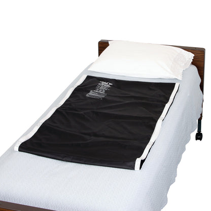 A hospital bed with an AliMed No-Lift BOOSTER pad on the mattress, covered by a white pillow and light blue bedding.