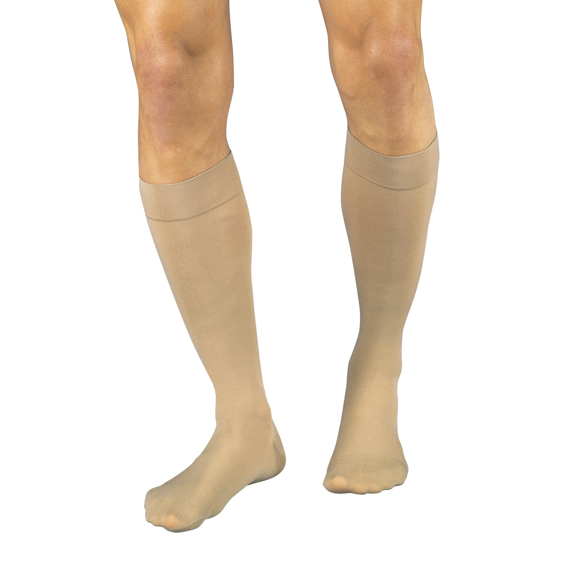 A person wearing Jobst Relief Thigh-High Compression Stockings, beige color, covering the legs from foot to mid-thigh.