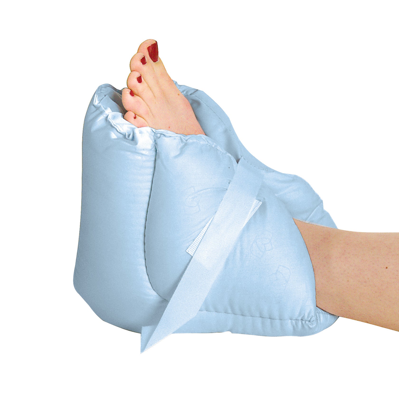 A person's foot with red toenails rests in a blue Spenco Silicore Foot Pillow, secured with a strap to provide comfort and support.