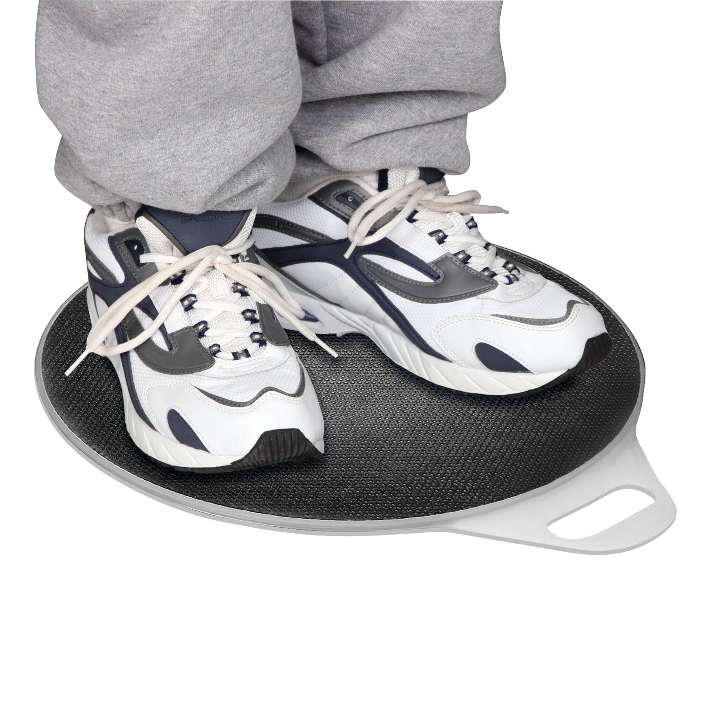 A person stands on a SafetySure Pivot Disc wearing white and gray athletic shoes and gray pants, using it to aid mobility or movement.
