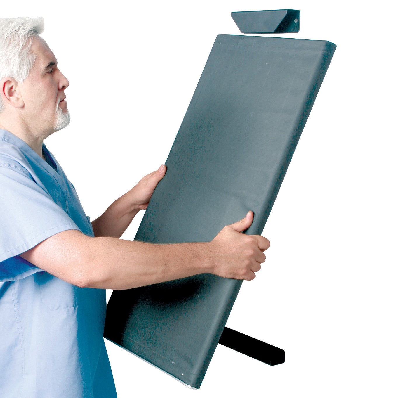 A person adjusts the AliMed Patient Roller Rack, a rectangular padded transfer aid for moving patients safely.