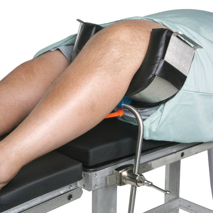 The AliMed Bariatric Universal Positioner supports legs with padded holders on a metal frame attached to a medical table.