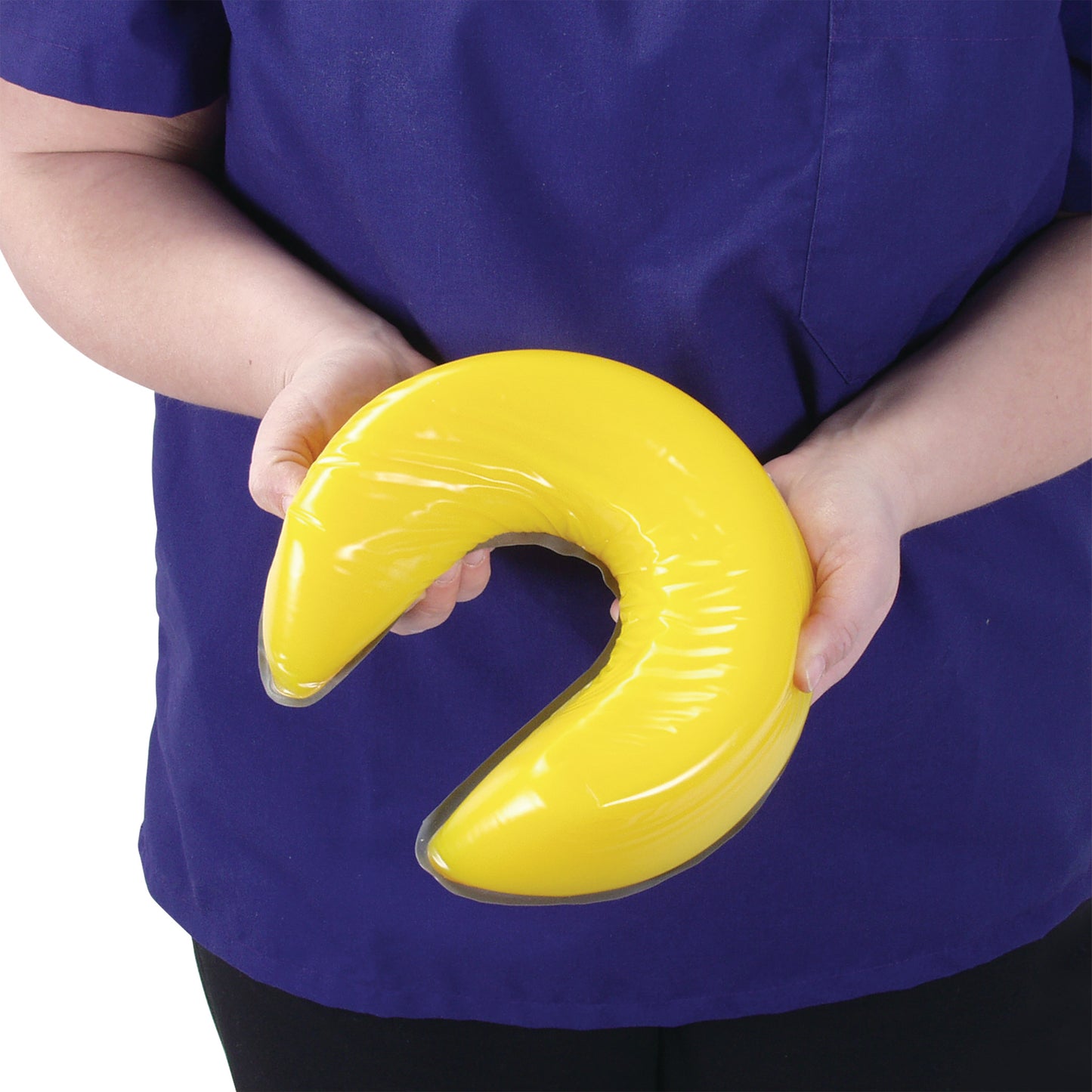 A person holds the yellow AliMed AliLite Horseshoe Positioner, wearing a blue shirt.