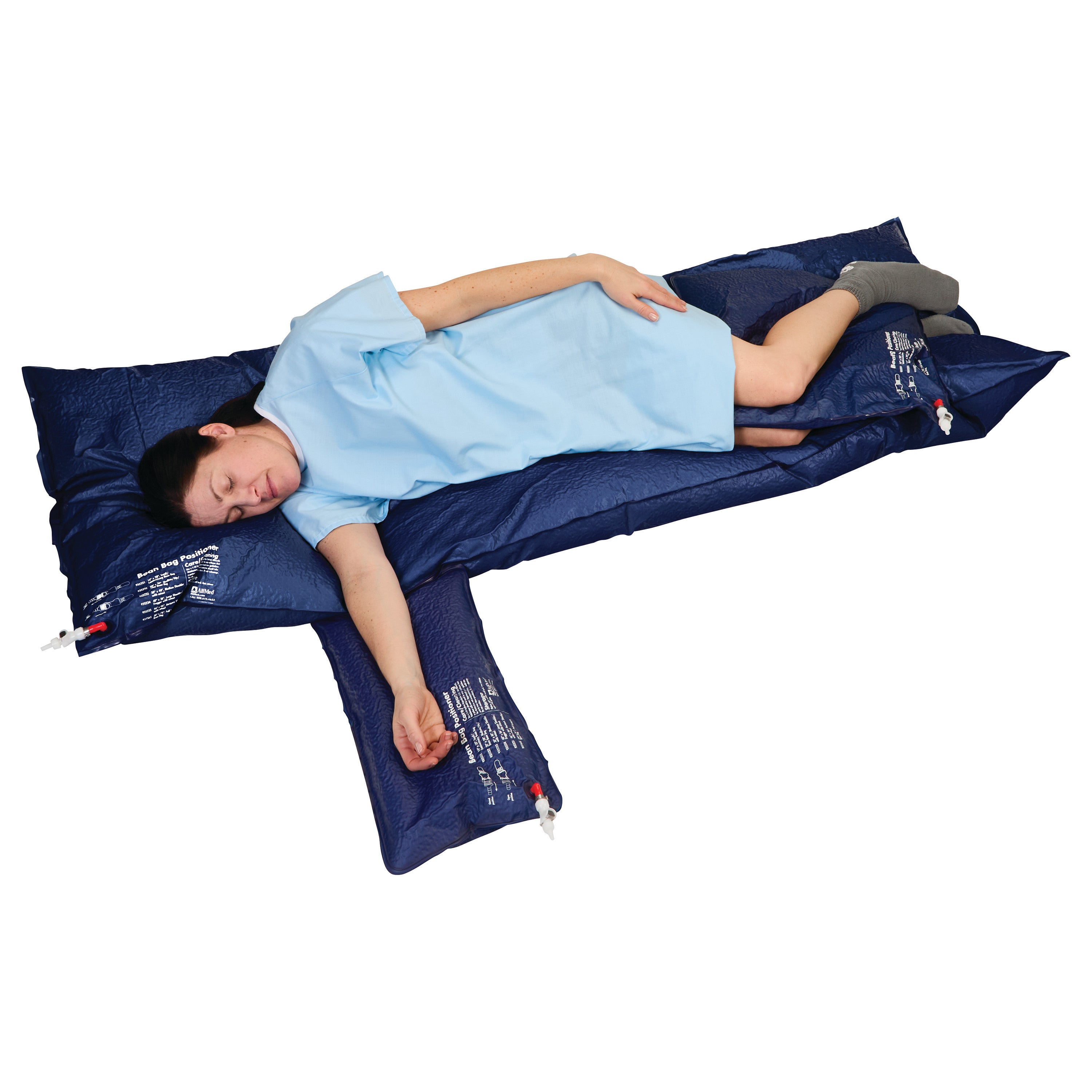 A person lies on an AliMed Universal Bean Bag Positioner, which supports the body in a lateral position, wearing a light blue gown.