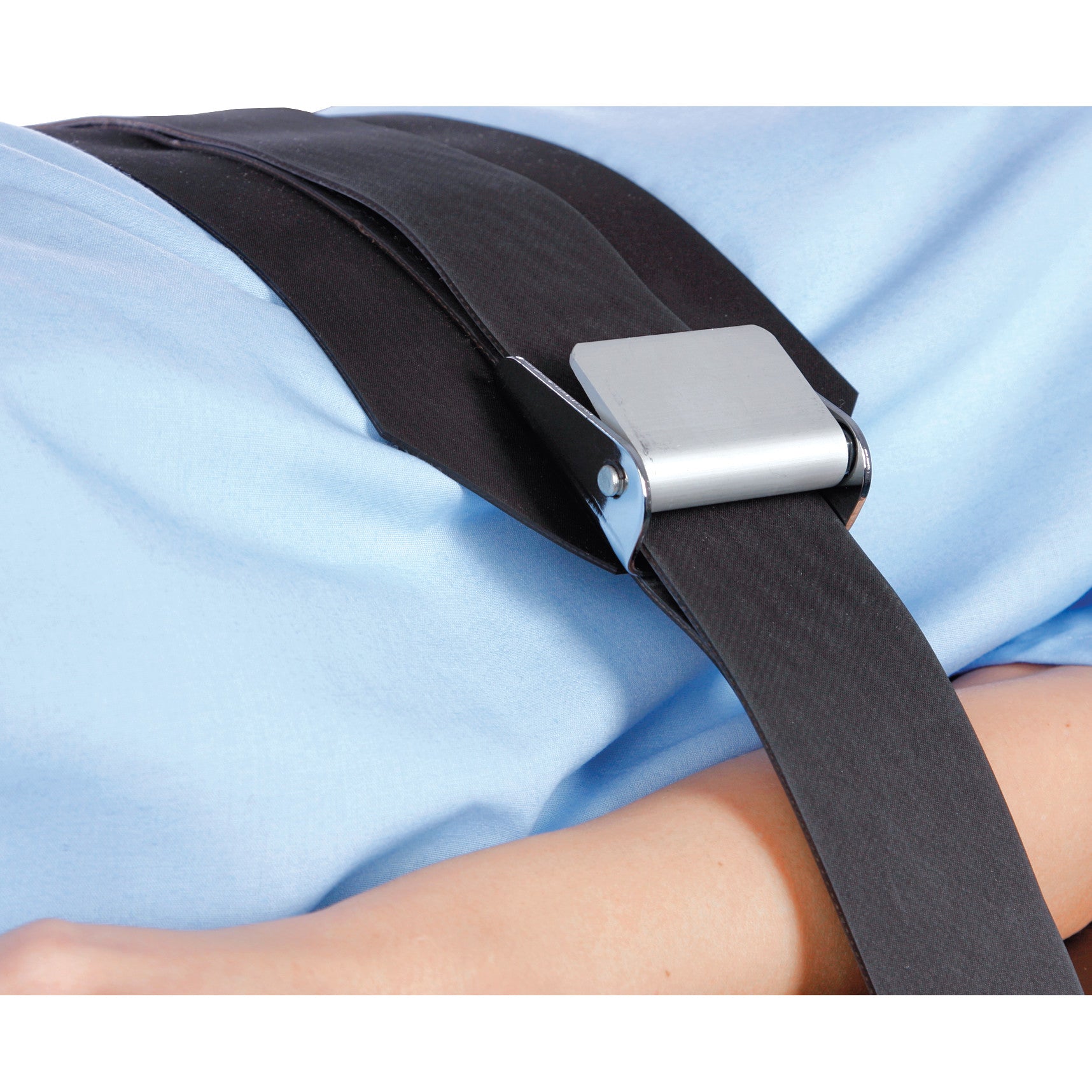 An AliMed Wipeable Operating Room Table Strap, secured over a person lying on a blue surface.