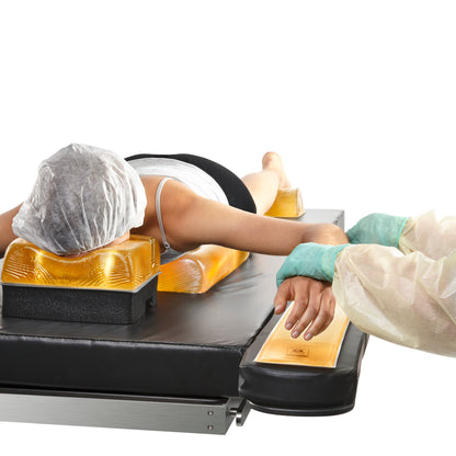 Person lying face down on a table using the AliMed AliGel Prone Positioning Set with gel pads for support.