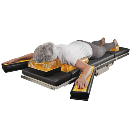 A person lies prone on the AliMed AliGel Prone Positioning Set, with gel cushions supporting the body on an adjustable table.