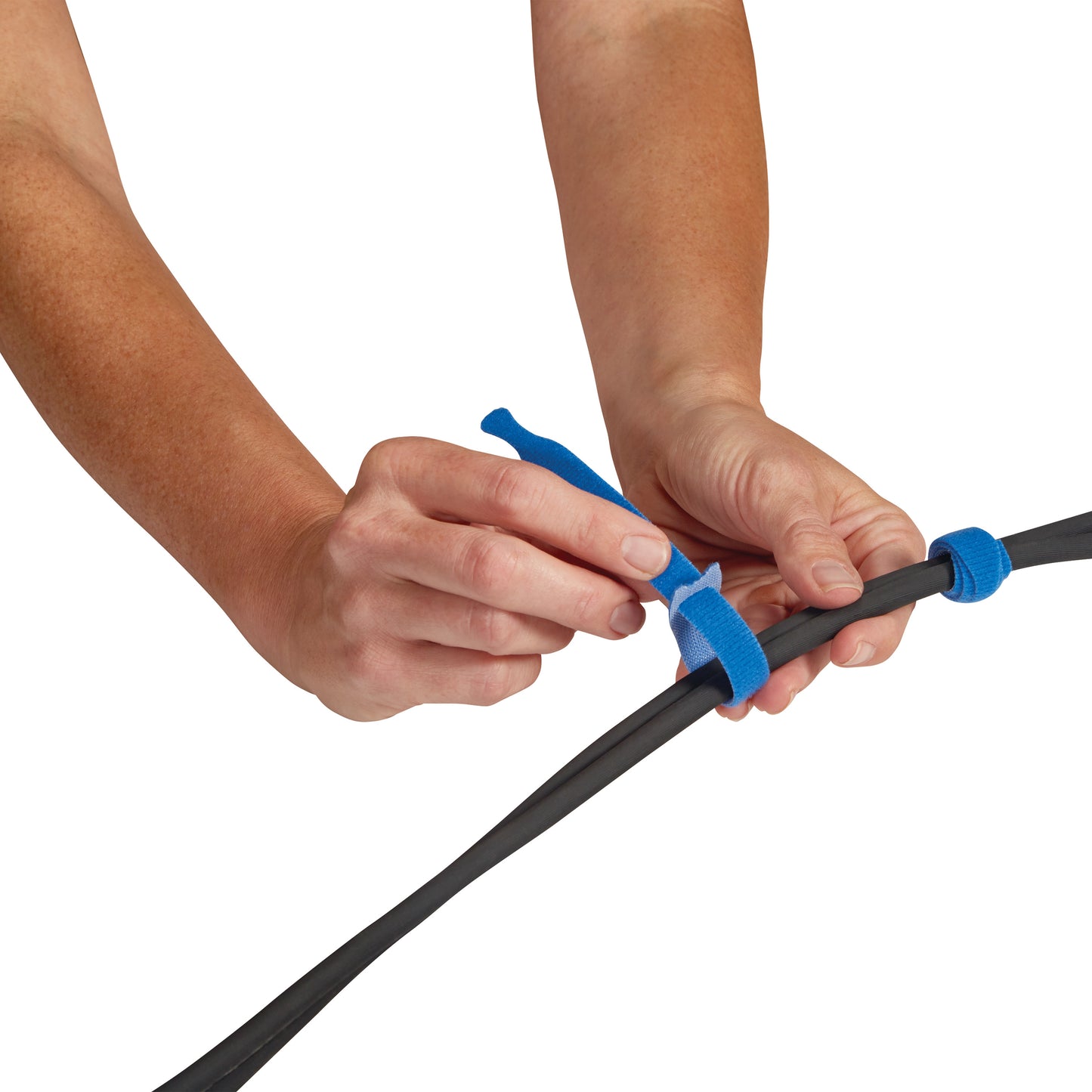 Hands are using blue AliMed AliTies to secure a black cable.