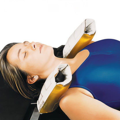 A woman lies on her back with AliMed AliGel Shoulder Support Pads on each side, wearing a blue top, against a plain background.