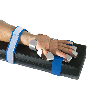 A hand secured on a black padded board with AliMed AliHand, featuring metal finger extensions and blue straps for stability.