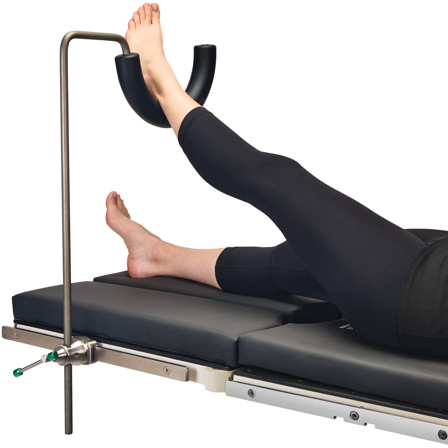 Person's leg in the AliMed Single-Leg Prepper and Clark Socket Plus Kit on a padded table for stabilization and support.