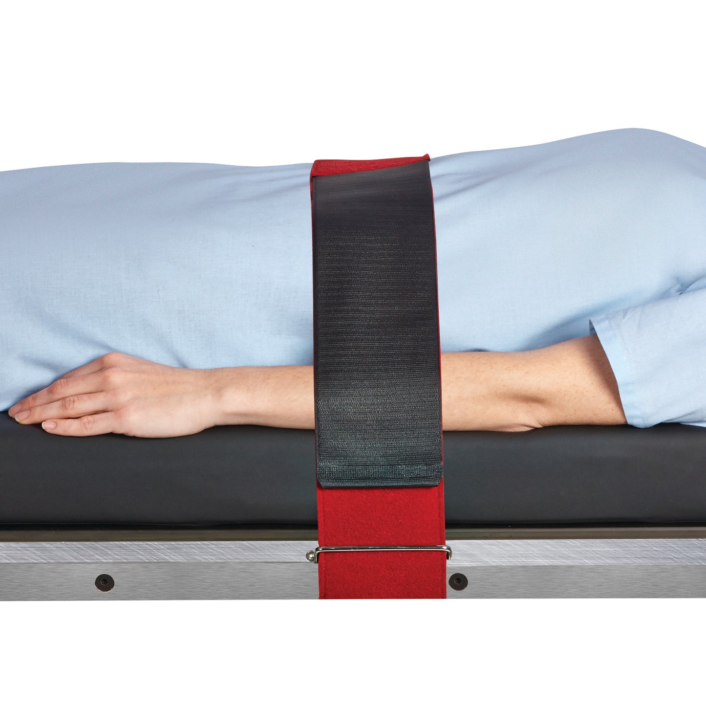 A person lies on a table with a Covidien Devon Reusable Body/Knee Strap securing them. The strap is black and red.