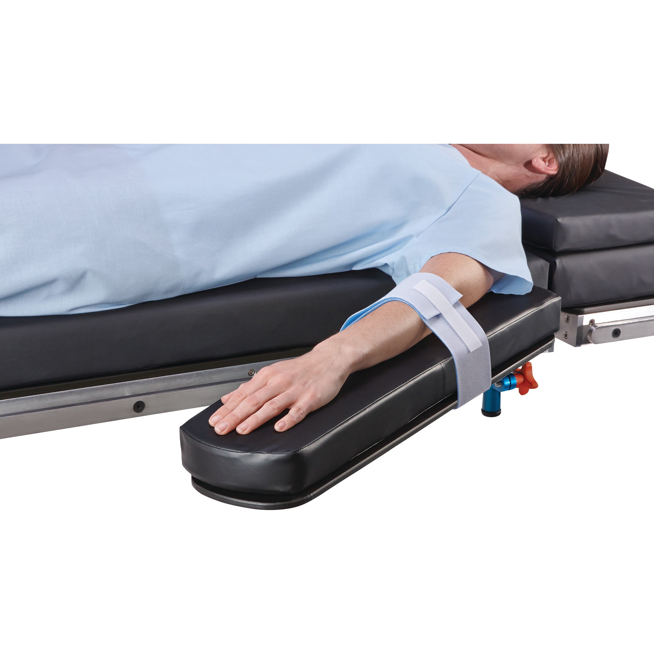 Person's arm is secured to an armboard with the AliMed Soft-Secure Armboard Strap, lying on a padded medical table.
