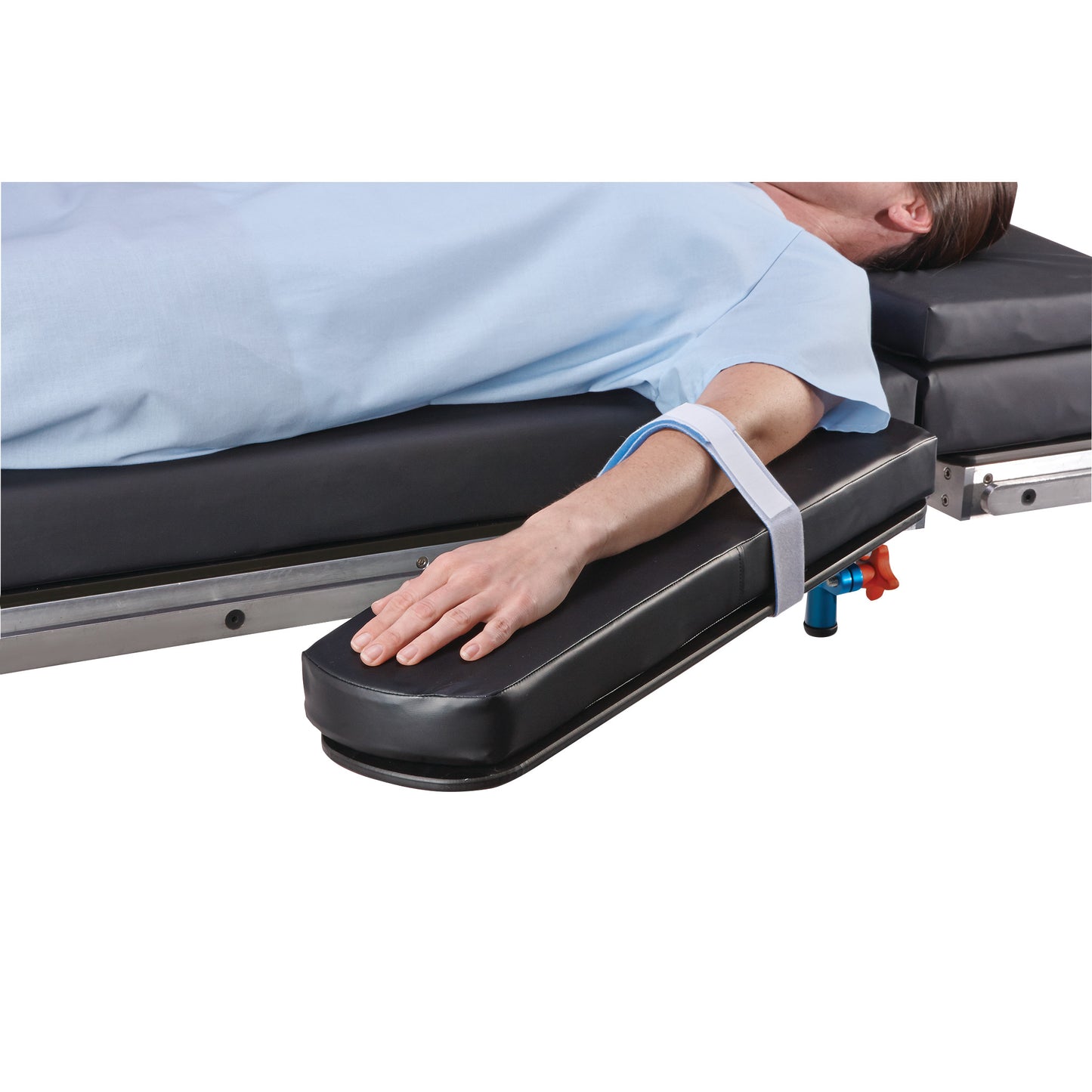 A person with an arm secured to a padded armboard using the AliMed Soft-Secure Armboard Strap, lying on a medical bed.