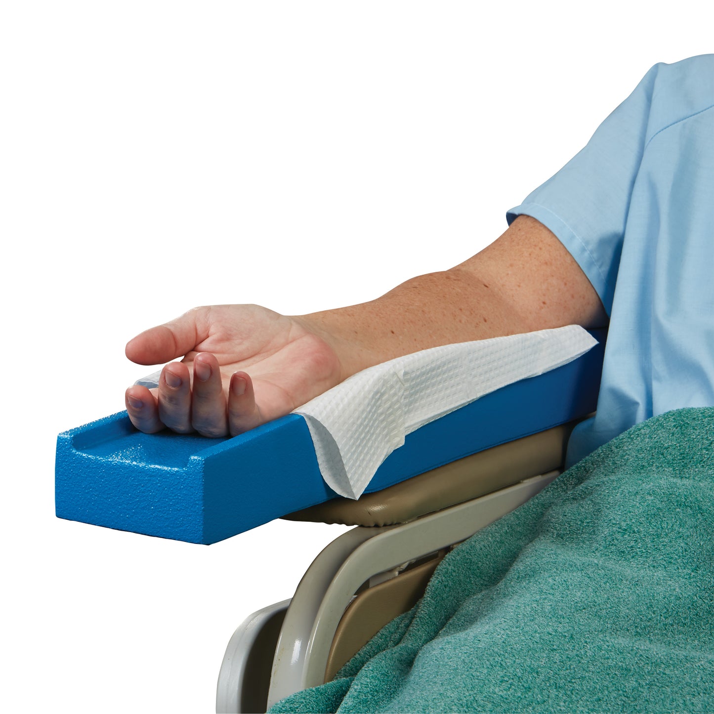 A forearm rests on an AliMed Dialysis Arm Positioner, a blue foam support, with a white paper sheet underneath.