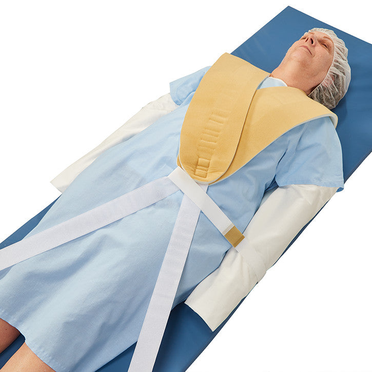 A person on a medical table wearing an AliMed Cervical Visualization Harness, featuring a neck support and straps.